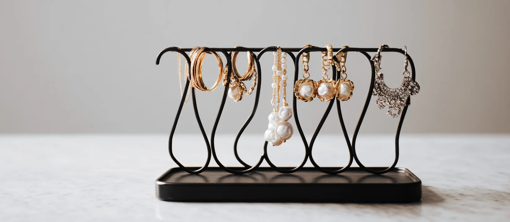 A creative and modern earring holder display with a striking earring holder metal frame, perfect for an earring display stand for selling.